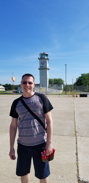 Shawn-stands-in-front-of-the-old-tower-at-Plattsburgh